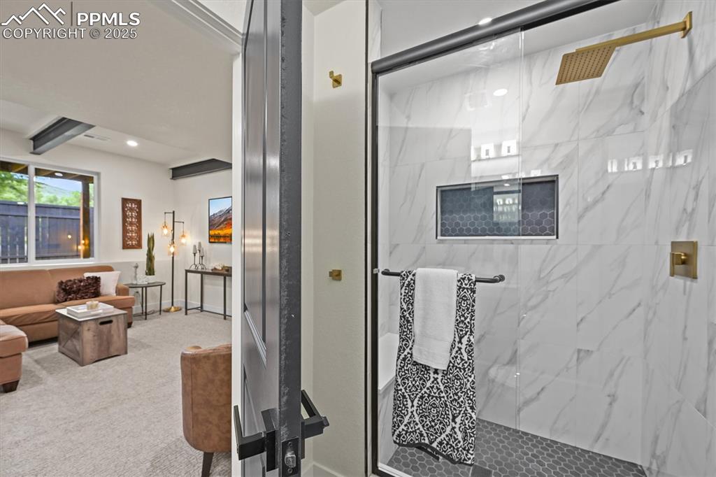 Image 13 of 47: Full bathroom with a marble finish shower, carpet flooring, and recessed li
