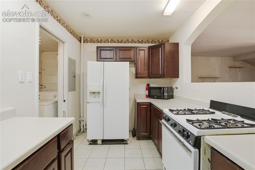 Image 16 of 36: KITCHEN INCLUDES A GAS RANGE AND CONNECTS TO A SEPARATE LAUNDRY AREA/MUD RO