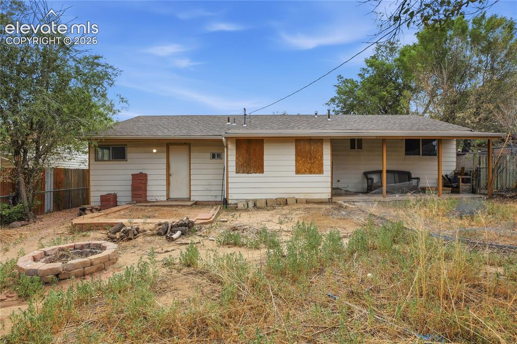 Image 33 of 36: BACKYARD ALREADY FEATURES A COVERED PATIO AND FIRE PIT