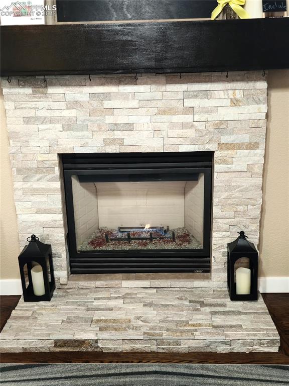 Image 14 of 48: Living room featuring a textured ceiling, a ceiling fan, a fireplace, wood