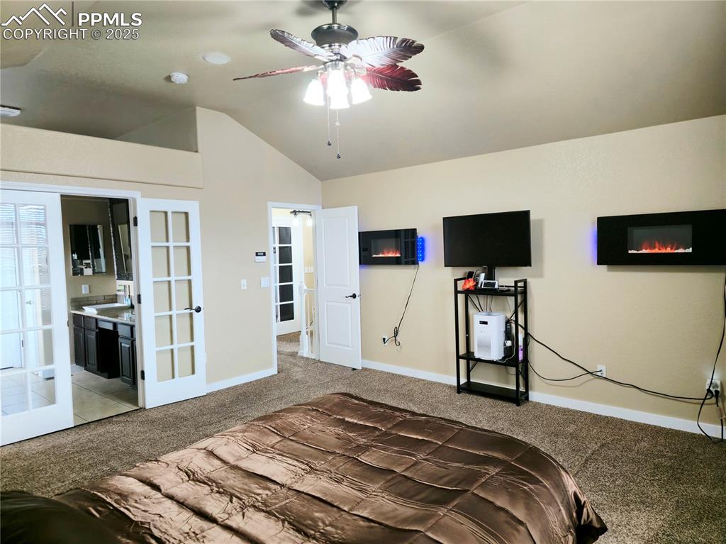 Image 33 of 48: Carpeted bedroom featuring vaulted ceiling, a textured ceiling, and ceiling