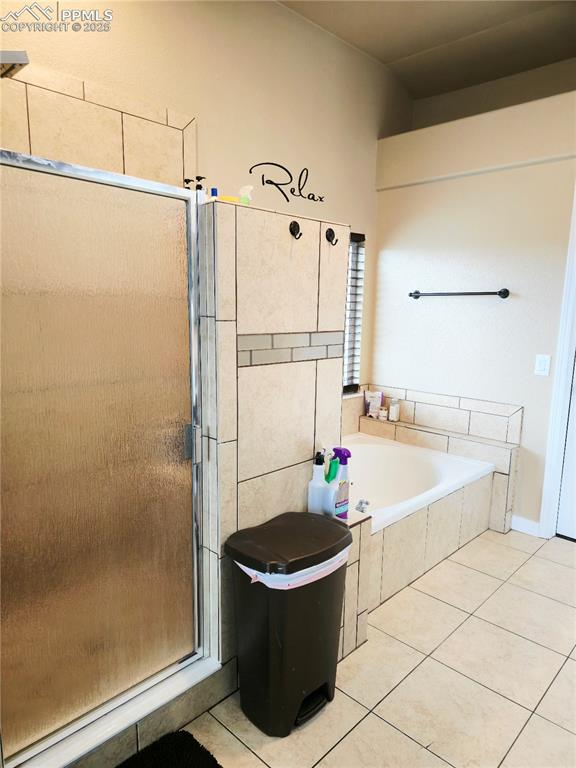 Image 35 of 48: Bathroom with connected bathroom, a relaxing tiled tub, tiled shower, vanit