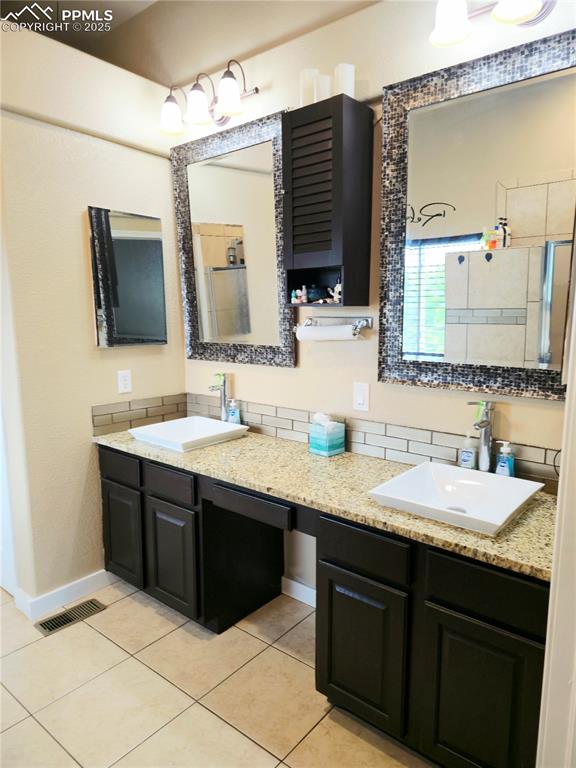 Image 36 of 48: Full 5 piece bathroom featuring tile patterned flooring, a bath, and a show
