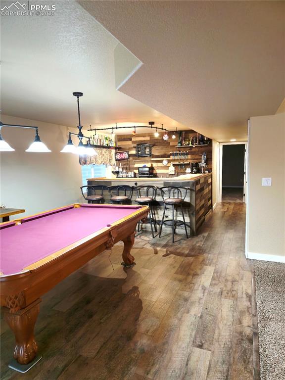 Image 41 of 48: Rec room with carpet flooring, ceiling fan, a glass covered fireplace, and