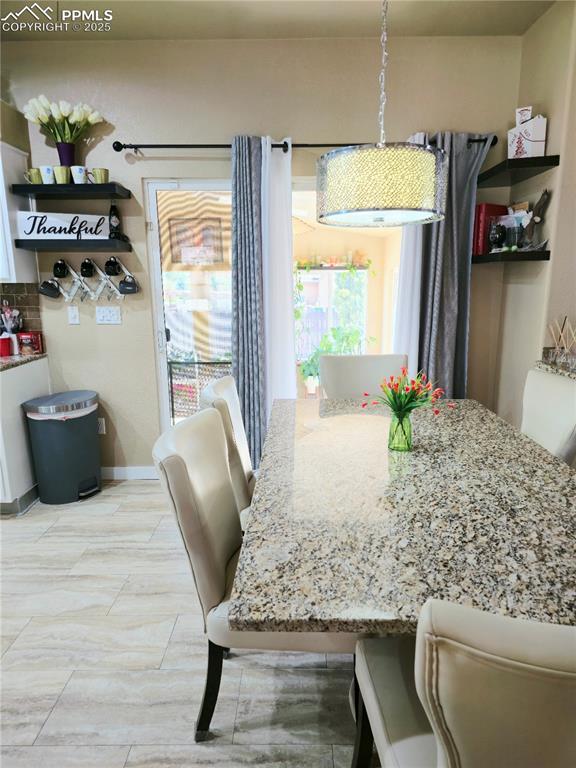 Image 8 of 48: Kitchen with a kitchen island, appliances with stainless steel finishes, ba