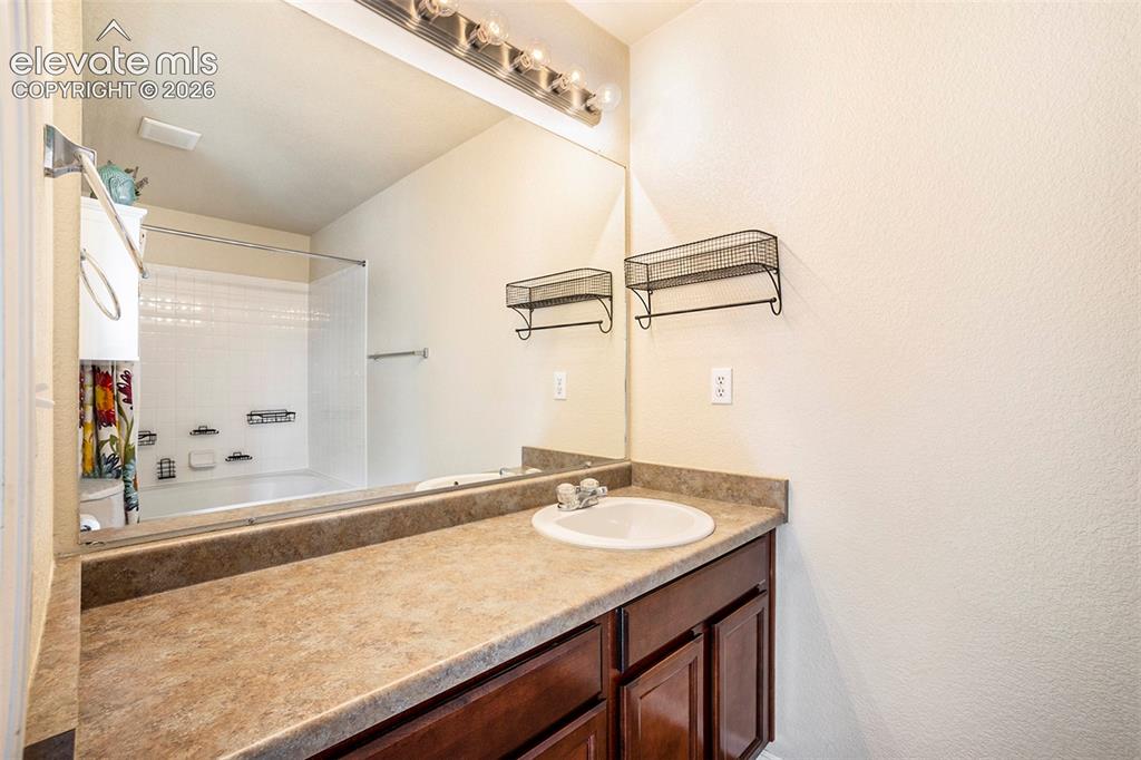 Image 16 of 24: Primary bath with lots of counter space and storage