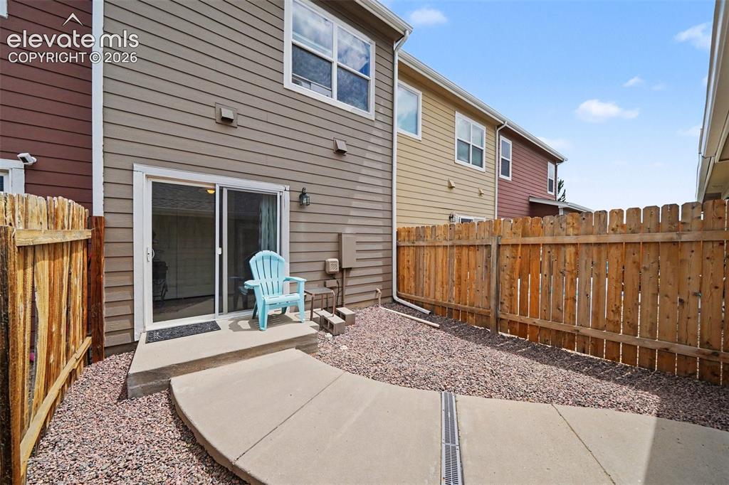 Image 21 of 24: Second outdoor living area leading to two car garage