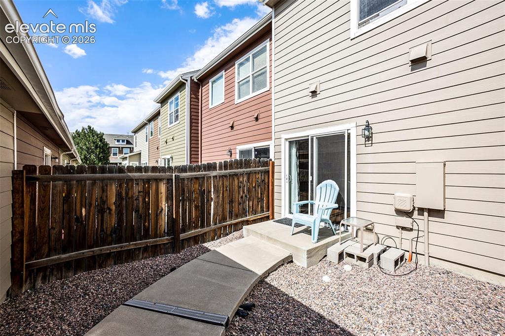 Image 22 of 24: View of back outdoor area from garage