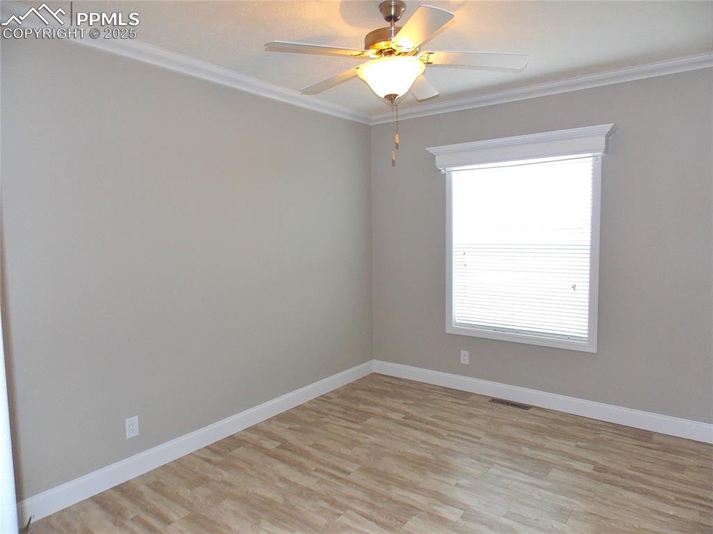 Image 17 of 33: Bedroom 2 with crown molding and Fan/Light