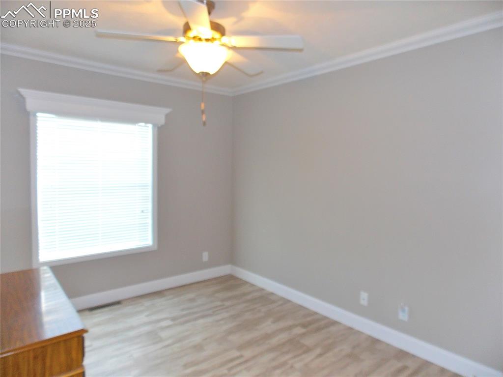 Image 18 of 33: Bedroom 3 with crown molding and Fan/light