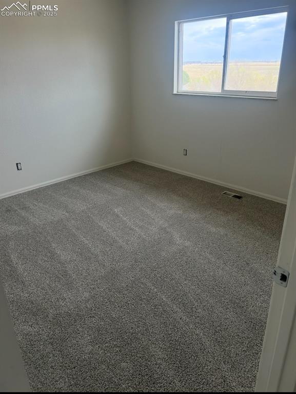 Image 5 of 8: Carpeted empty room with baseboards