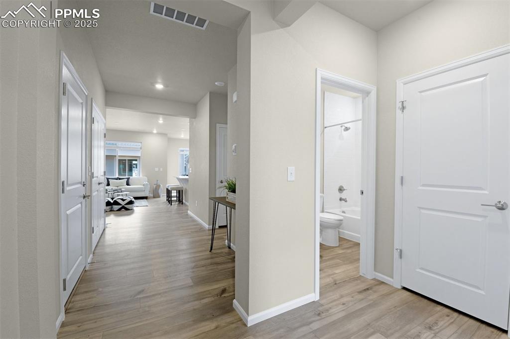 Image 11 of 28: Hall featuring light wood-style flooring and recessed lighting