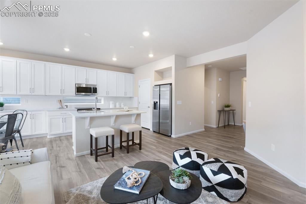 Image 15 of 28: Living room featuring recessed lighting and light wood-style floors
