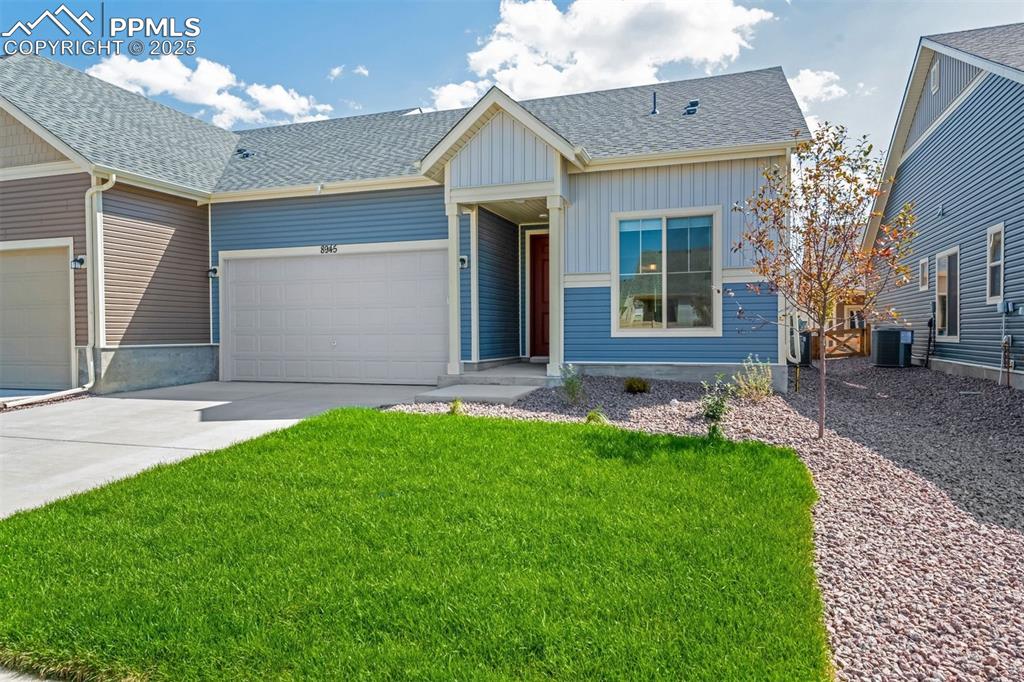 Image 2 of 28: View of front facade featuring a shingled roof, concrete driveway, a garage