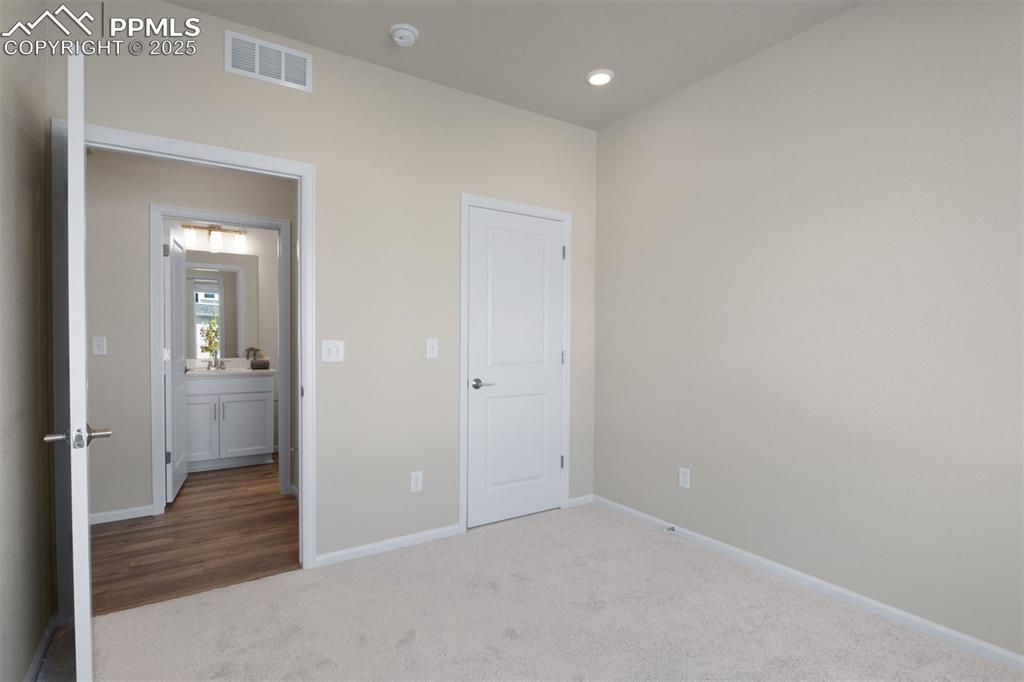 Image 27 of 28: Unfurnished bedroom with carpet flooring and recessed lighting