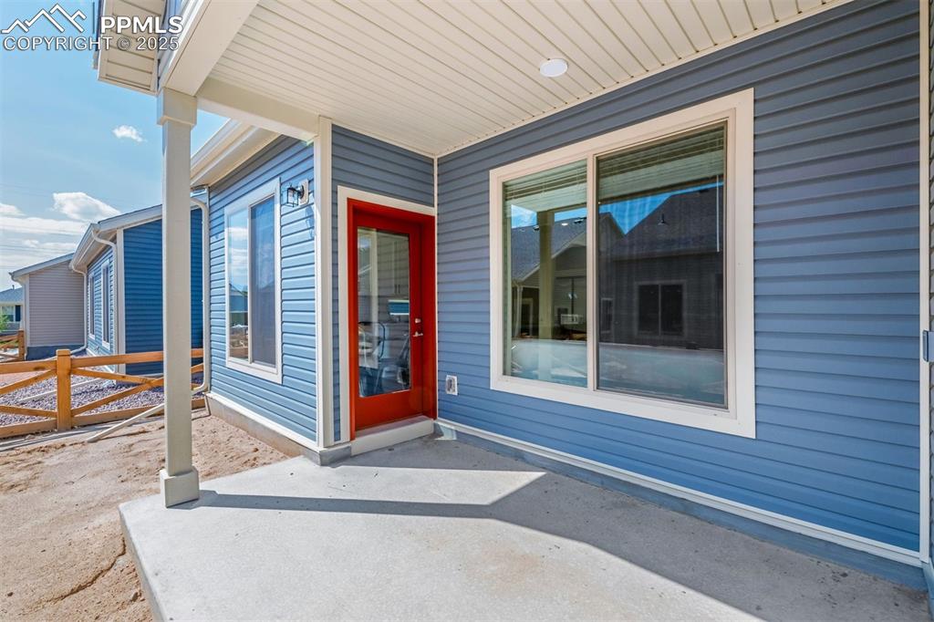 Image 6 of 28: View of exterior entry featuring a patio