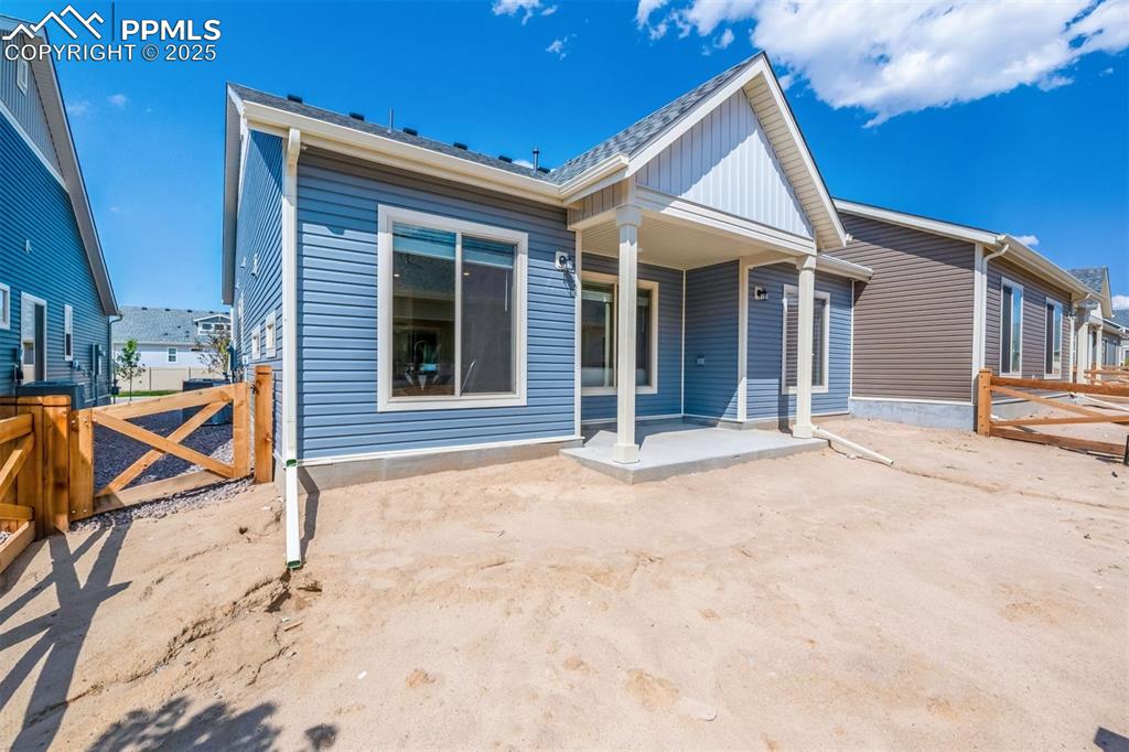 Image 9 of 28: Back of property featuring a patio area and a gate