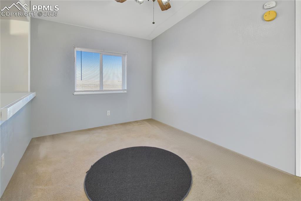 Image 17 of 34: Spare room featuring carpet, a ceiling fan, and lofted ceiling