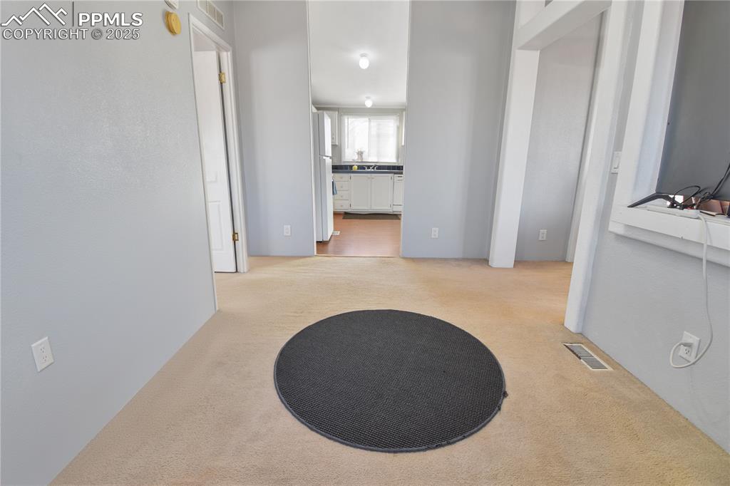 Image 18 of 34: Corridor featuring light carpet