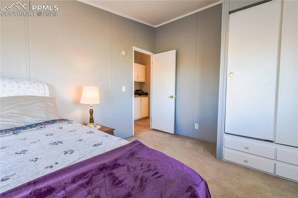 Image 22 of 34: Bedroom featuring light colored carpet