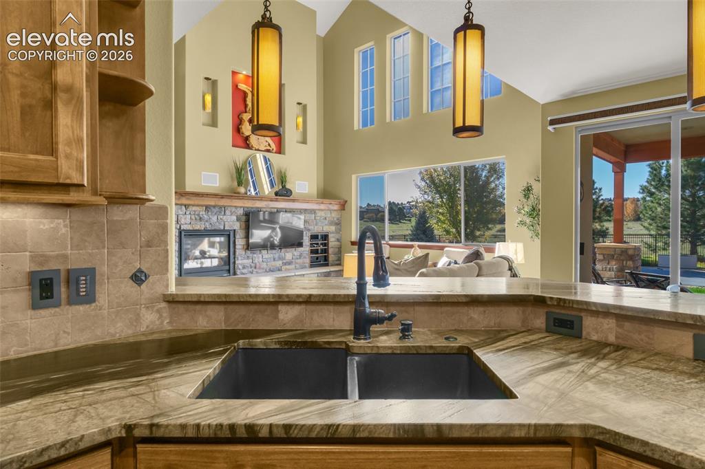 Image 29 of 50: Kitchen featuring stone-surface countertops, dual basin undermount sink wit