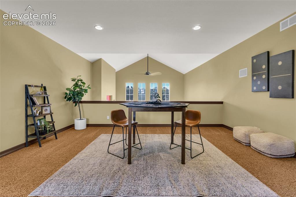Image 39 of 50: Vaulted ceiling, four-pane vertical window configuration, recessed lighting
