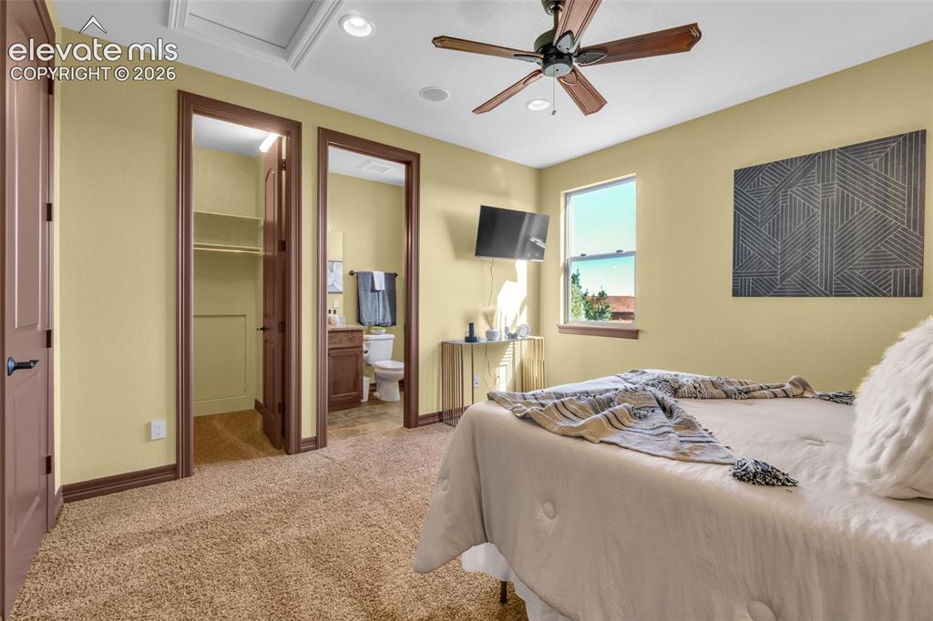 Image 43 of 50: Bedroom featuring carpeted flooring, a ceiling fan with integrated lighting