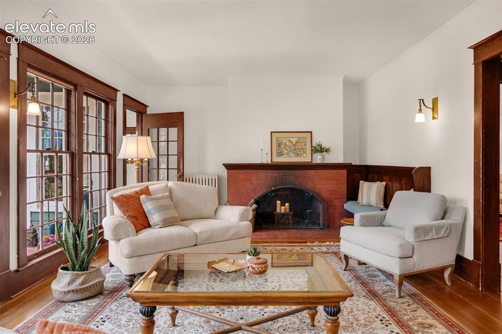 Image 11 of 50: Freshly painted, bright, open Living Room with wood burning fireplace (need