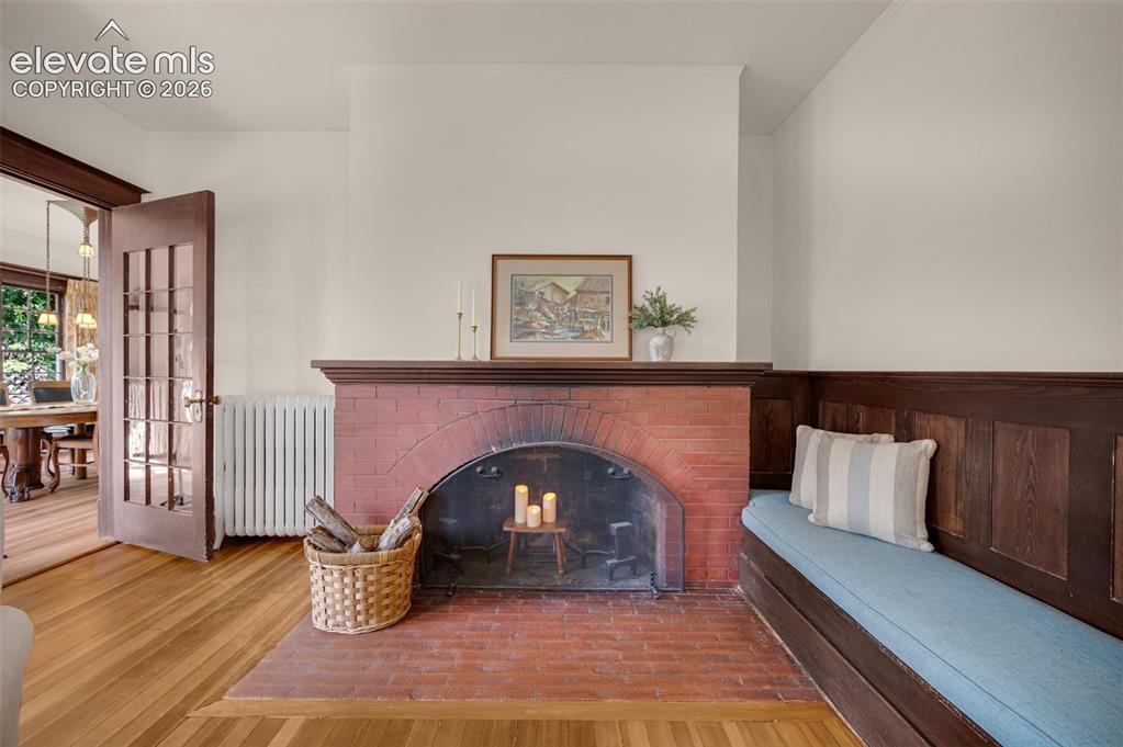 Image 14 of 50: Original 1911 wood fireplace. Needs one more sleeve to be fully functional.