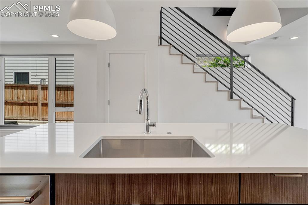 Image 14 of 49: Kitchen with light countertops and recessed lighting