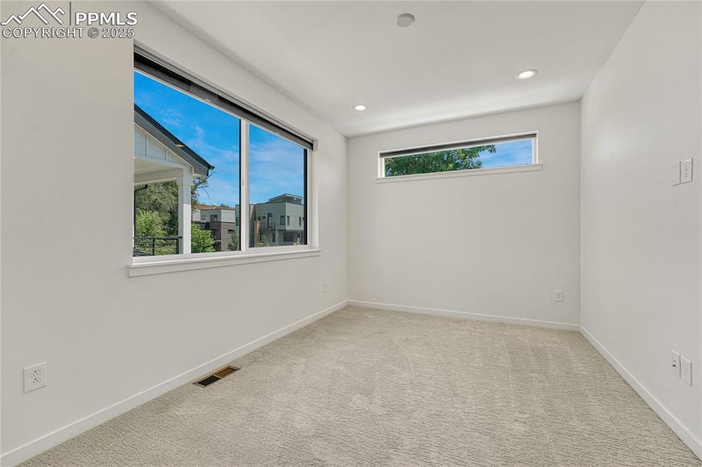 Image 20 of 49: Carpeted spare room with recessed lighting