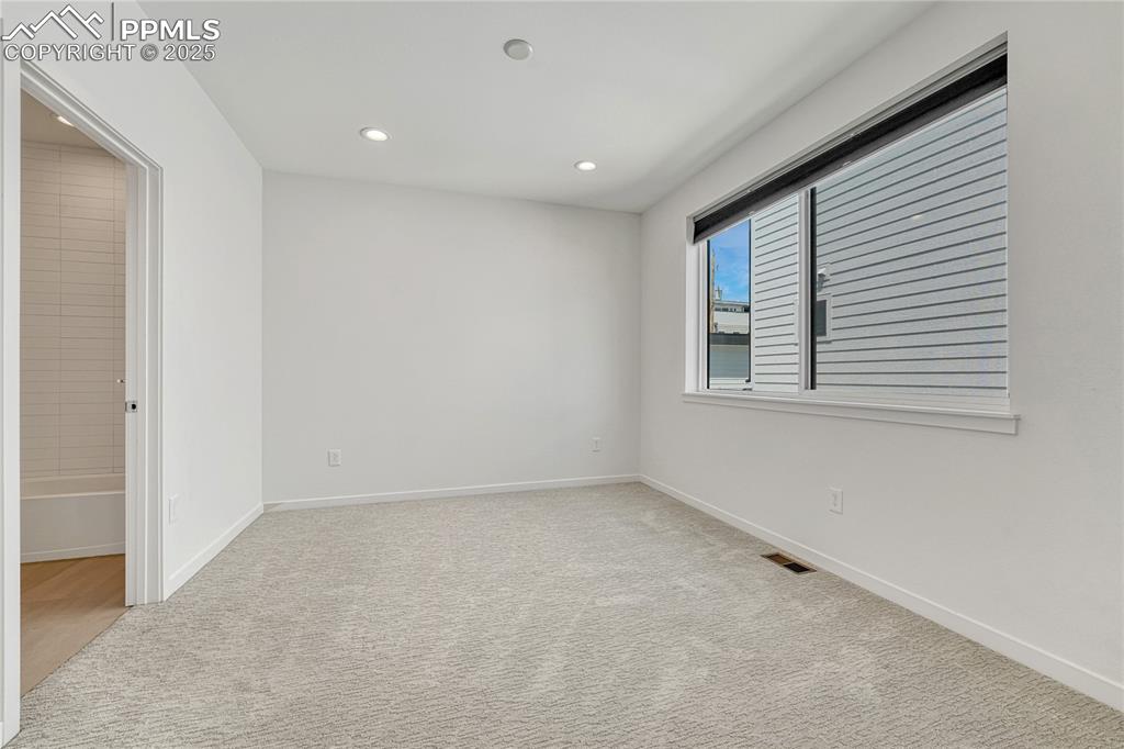 Image 26 of 49: Unfurnished room with carpet and recessed lighting
