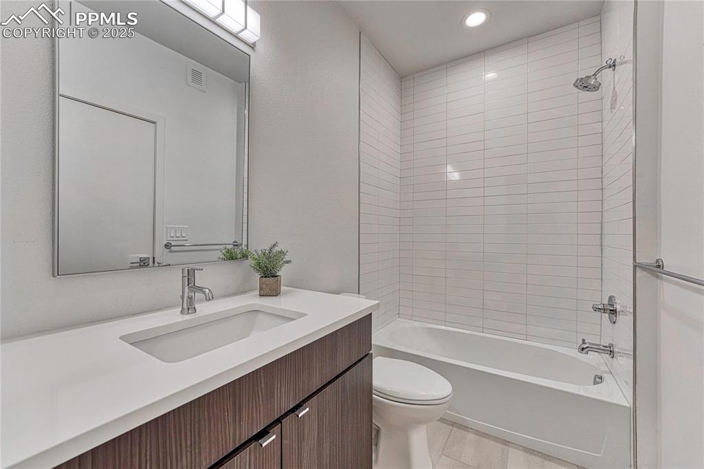 Image 30 of 49: Full bath featuring vanity, shower / tub combination, recessed lighting, an