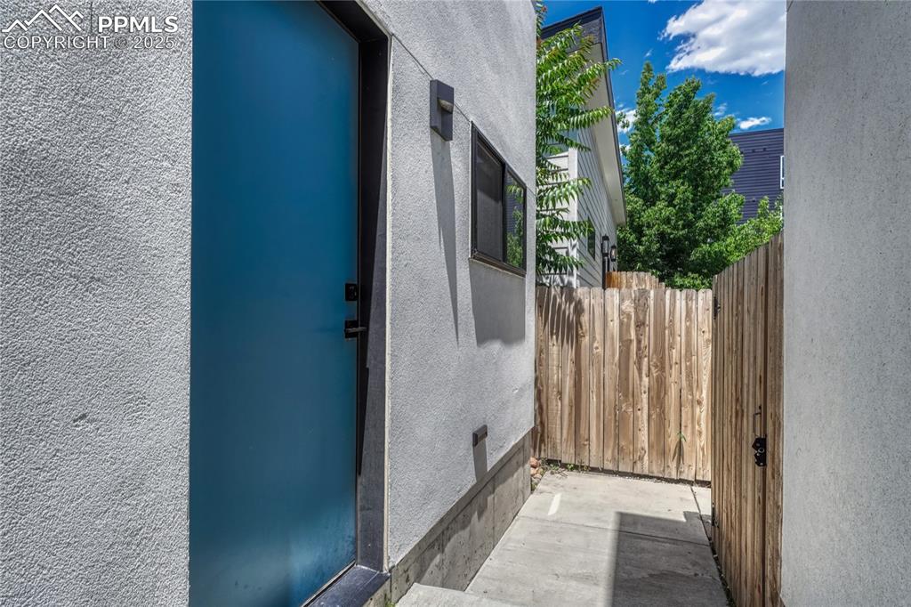 Image 41 of 49: Doorway to property with stucco siding