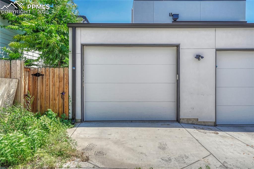 Image 44 of 49: Garage with concrete driveway