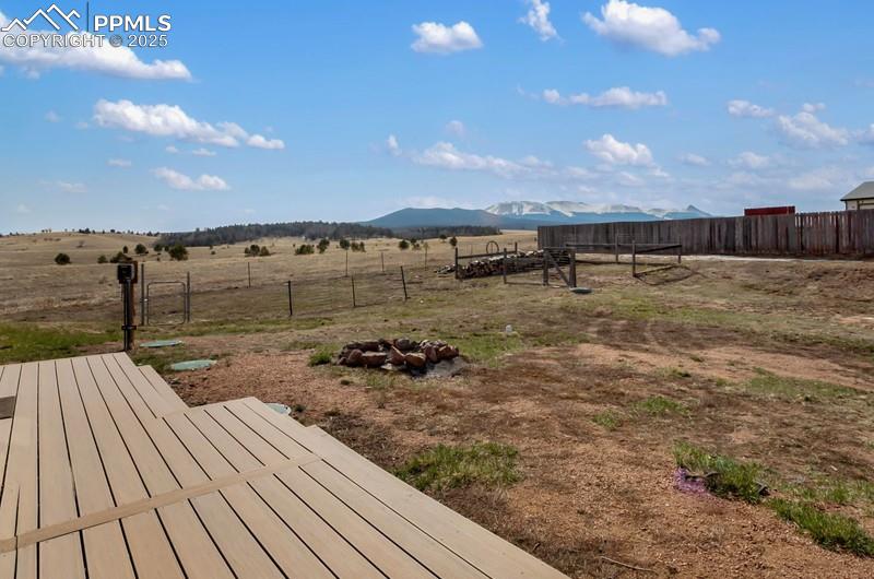 Image 28 of 32: View of yard featuring a rural view, a mountain view, and fence