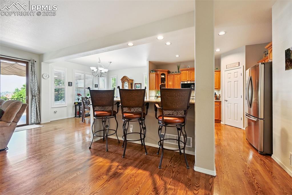 Image 12 of 45: Kitchen featuring stainless steel appliances, a kitchen breakfast bar, a ch