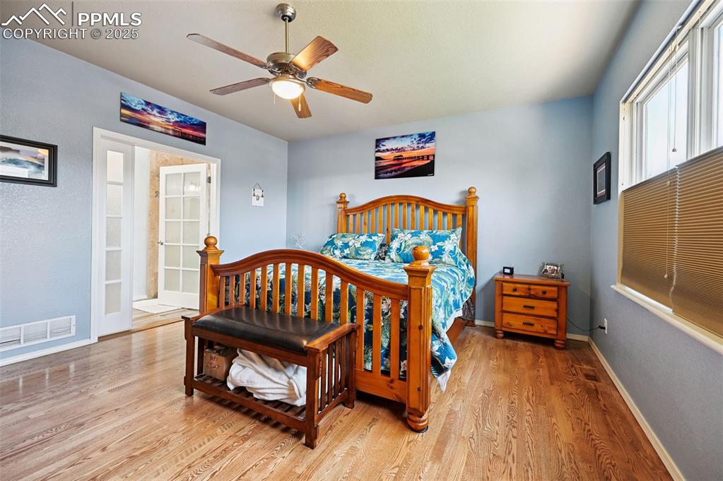 Image 21 of 45: Bedroom featuring wood finished floors and ceiling fan