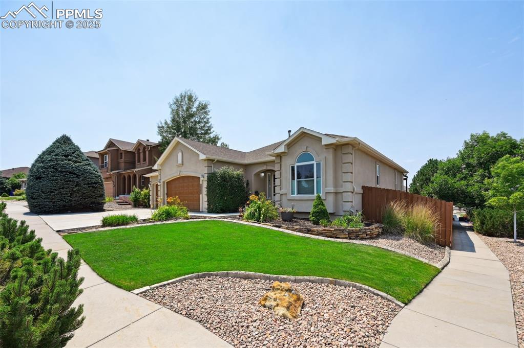 Image 3 of 45: View of front of property with stucco siding, concrete driveway, and an att