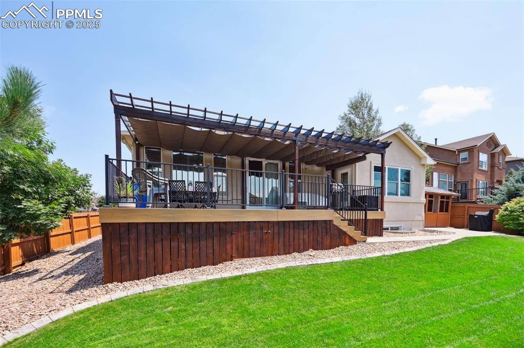 Image 41 of 45: Rear view of property featuring a pergola, stairs, and stucco siding