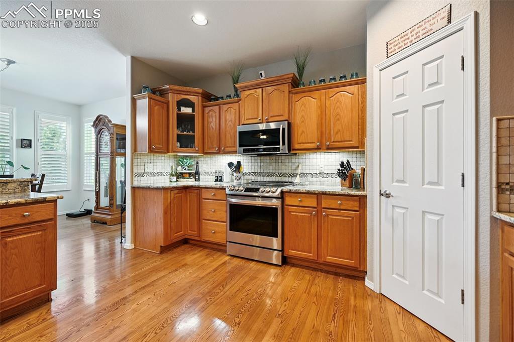 Image 8 of 45: Open kitchen with stainless appliances and a large pantry 