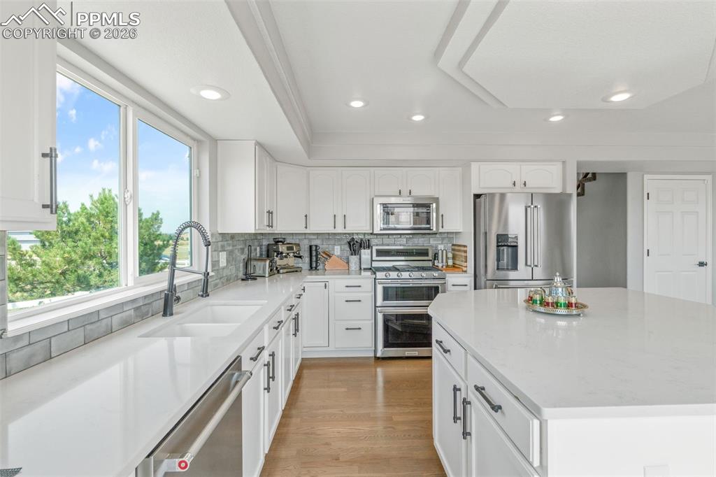 Image 17 of 47: Kitchen with stainless steel appliances, a kitchen island, light wood-type 