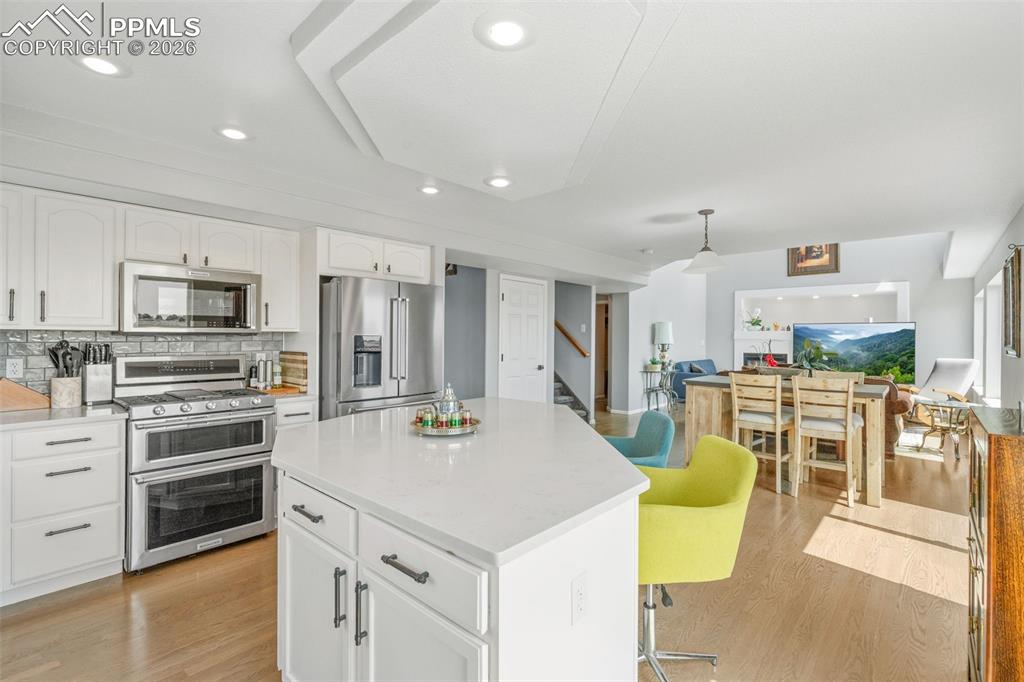 Image 18 of 47: Kitchen featuring stainless steel appliances, light wood-style flooring, wh