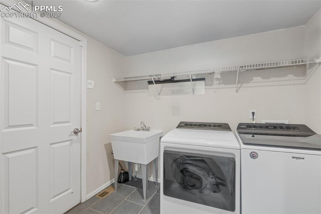 Image 34 of 47: Laundry room with independent washer and dryer and baseboards