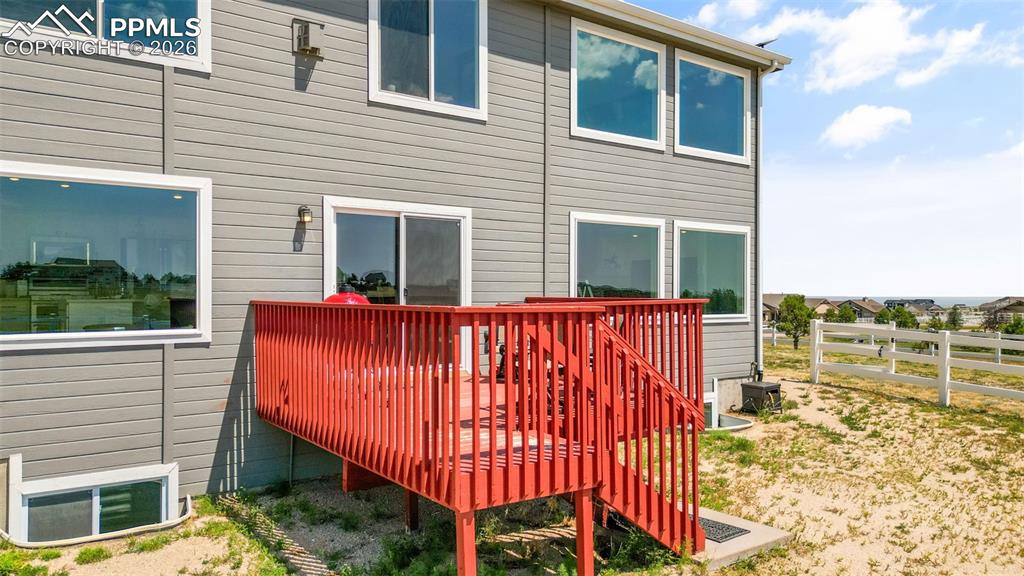 Image 35 of 47: Rear view of house featuring a wooden deck