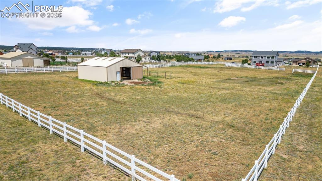 Image 41 of 47: View of yard with an outdoor structure, a pole building, a residential view
