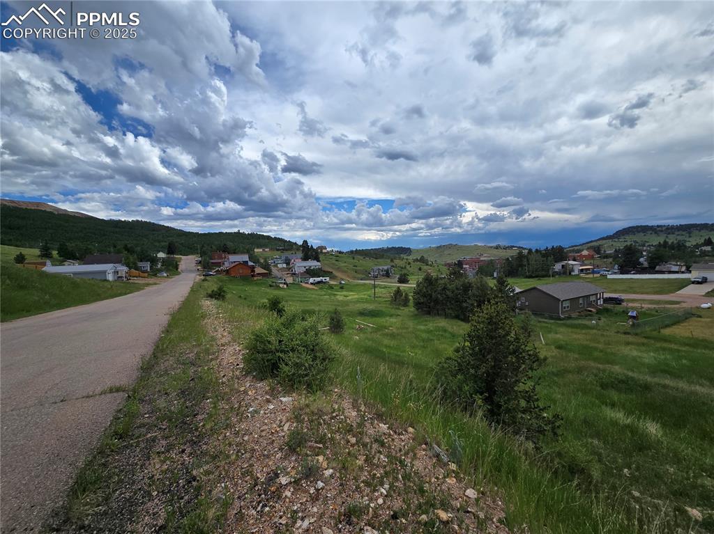 Image 4 of 4: View of asphalt road featuring a mountain view and a view of rural / pastor