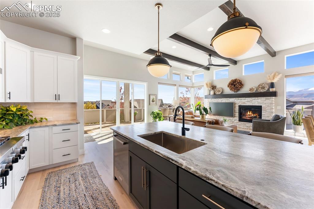 Image 18 of 50: Large island has a large undermount stainless kitchen sink and stainless di