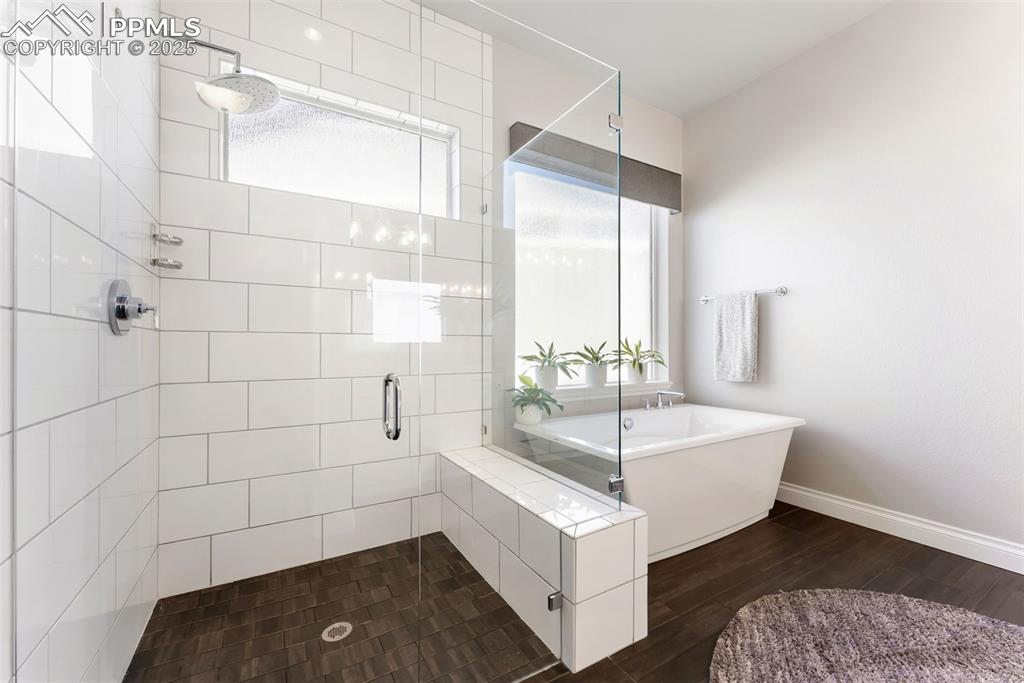 Image 24 of 50: Rain shower head and frosted windows to brighten up the space while adding