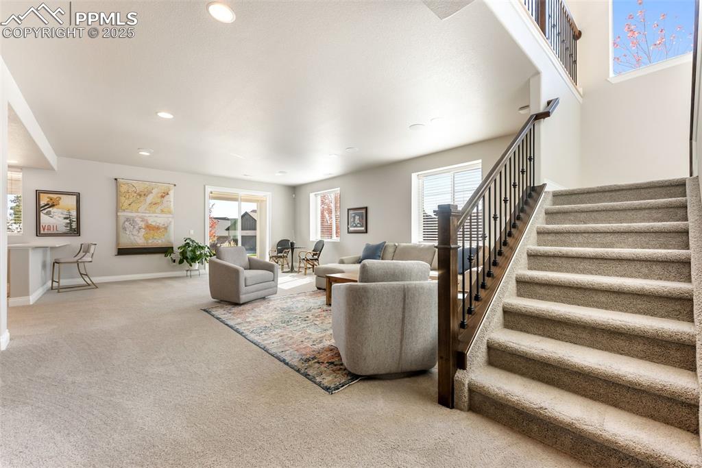 Image 31 of 50: Head downstairs to the large family room with walk-out access to the back y